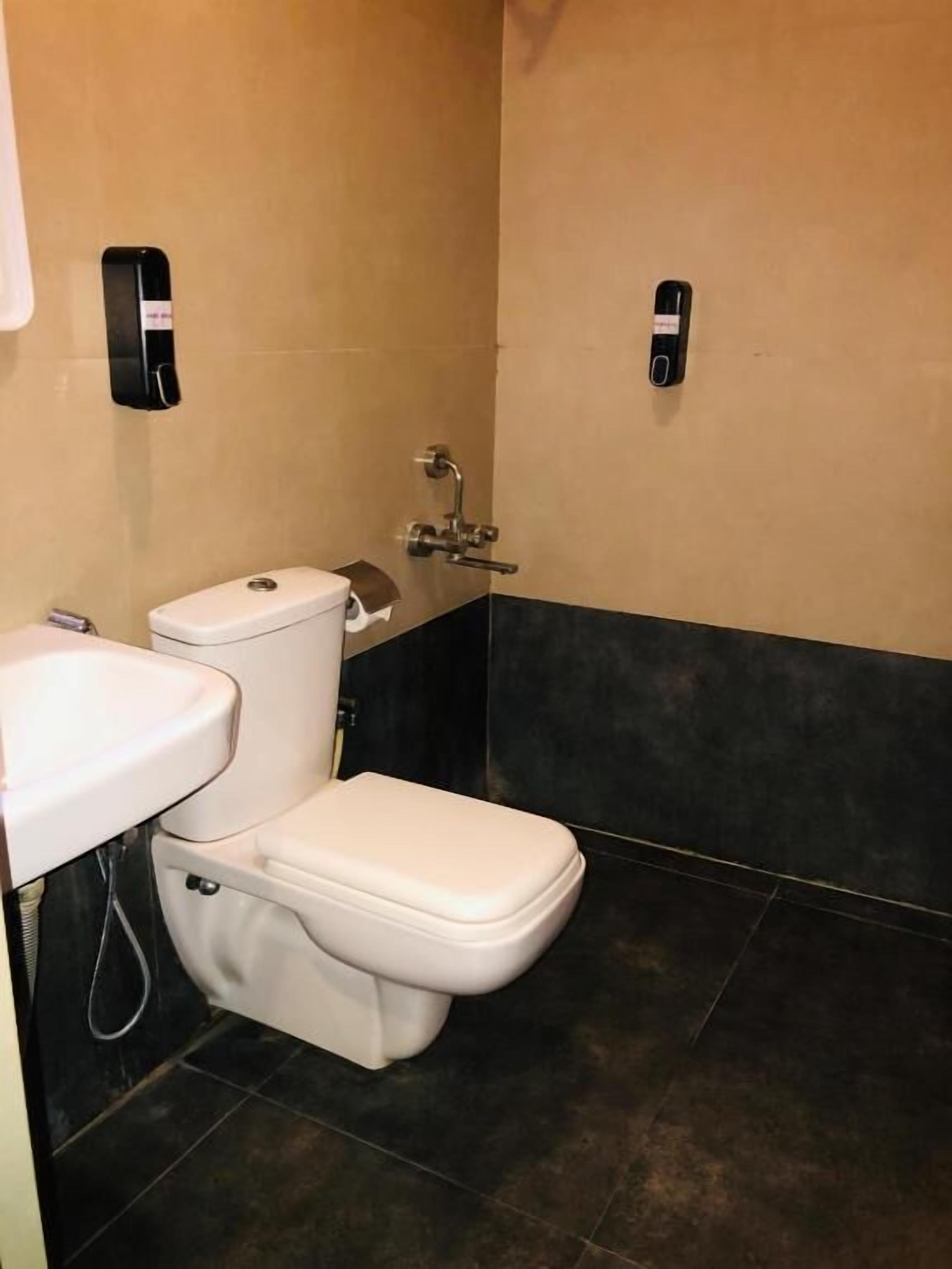 A bathroom with a toilet, a sink, and a shower.