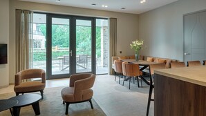 Un comedor moderno con una mesa grande, sillas y un televisor.