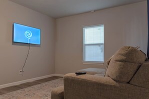 Living area - Cozy mid-century bungalow just minutes from Downtown Fort Worth. Enjoy modern comforts, a warm inviting atmosphere, and thoughtfully designed spaces—perfect for relaxing after exploring the city, dining, and local attractions. (Fort Worth)