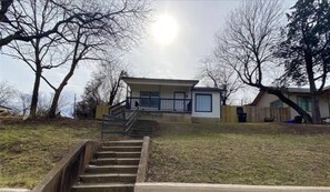 Exterior - Cozy mid-century bungalow just minutes from Downtown Fort Worth. Enjoy modern comforts, a warm inviting atmosphere, and thoughtfully designed spaces—perfect for relaxing after exploring the city, dining, and local attractions. (Fort Worth)