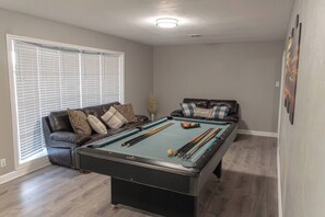 Games room - Experience farmhouse charm in this spacious 4-bedroom ranch retreat in Gainesville. Just minutes from downtown, the Frank Buck Zoo, and local parks, this cozy getaway sleeps up to 10 guests. Enjoy a bright open layout, comfortable country-style livin (Gainesville)