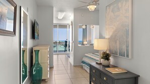 A hotel room with a bed, dresser, artwork, and a view of the ocean. - Destin West Studio Villa 501 ~ Amazing Ocean Views ~ Free Beach Service (Fort Walton Beach)