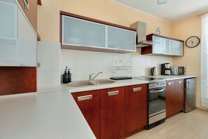 Eine moderne Küche mit Backofen, Spüle und Kaffeemaschine.