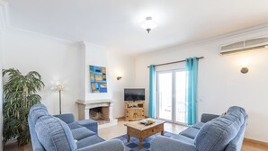 A living room with two sofas, a coffee table, a TV, and a fireplace. - Villa Nina With 4 Bedrooms and 4 Bathrooms (Olhao)
