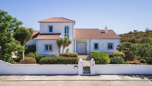 A two-story house with a tiled roof, a white exterior, and a gated entrance. - Villa Nina With 4 Bedrooms and 4 Bathrooms (Olhao)