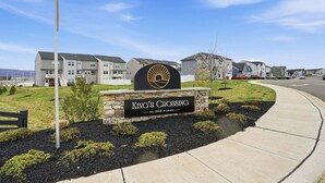 A residential area with a sign for 'King's Crossing by DRB Homes' and modern apartment buildings. - New 4br Townhome Near Harpers Ferry 4 Bedroom Townhouse (Charles Town)
