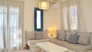 A living room with a sofa, a coffee table, and a lamp.