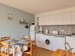 A compact kitchen with a washing machine, a microwave, and a coffee maker. - House with South-Facing Enclosed Garden (La Tranche-sur-Mer)