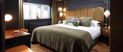 A bedroom with a bed, bedside tables, a window, and a chair.