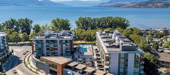 Modern 2-bedroom condo with king beds in Kelowna across from Gyro Beach. Features a stunning 1,700 sq ft rooftop deck with lake views plus pool, hot tub, gym, and sauna.