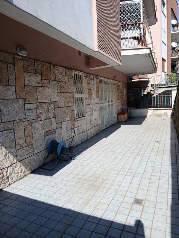 A building with stone walls, metal gates, and a tiled floor.