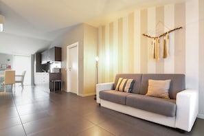 Deluxe Apartment, Balcony | Living area | 30-cm TV with digital channels