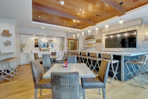 A modern kitchen with a large island, wooden ceiling, and pendant lighting. - Flagstaff Lodge Condo by InvitedHome | Ski-In/Out, Shuttle, Deer Valley, Apres (Park City)