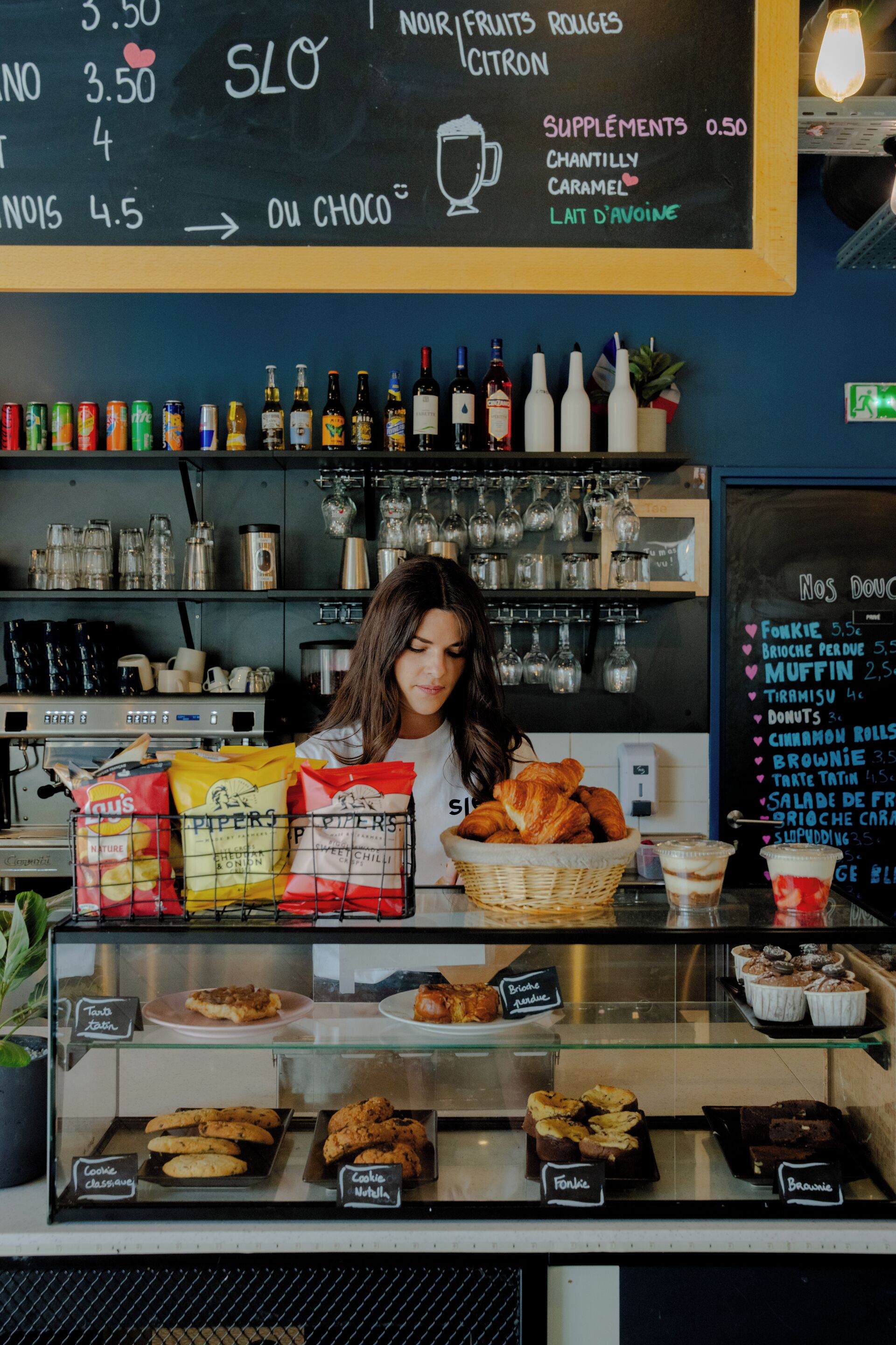 A bakery counter with a menu, snacks, and pastries.