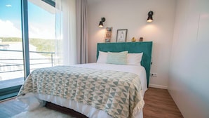 A bedroom with a bed, a window, and a view of the outside. - Travessa Apartments 3 Bedrooms By PontaNegraAzores (Praia da Vitória)