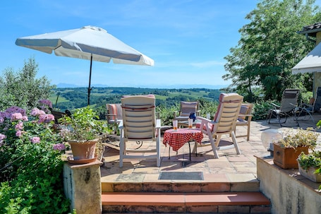 A patio with outdoor seating, a table, and a view of the countryside.. Characterful Villa with Charm, Le Paradis 4 Stars. Style, Comfort & Serenity, Private Pool