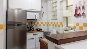 A kitchen with white cabinets, a stainless steel refrigerator, a microwave, and a coffee maker. - 15min From Flamengo Beach Oc107b (Rio de Janeiro)
