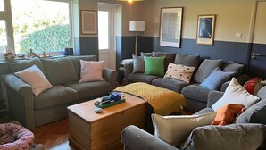 Un salon avec deux canapés, une table basse et une lampe.