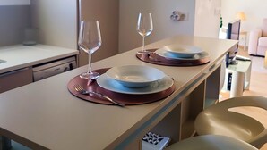 Eine moderne Küche mit Essbereich, einer Mikrowelle und einer Pendelleuchte.