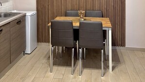 A modern kitchen with a built-in stove, a sink, and wooden cabinets. - IL PALAZZETTO GAETA (Gaeta)