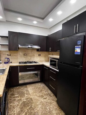 Microwave, oven, stovetop, cookware/dishes/utensils - ELITE New Modern 3BR Apartment (New Cairo)
