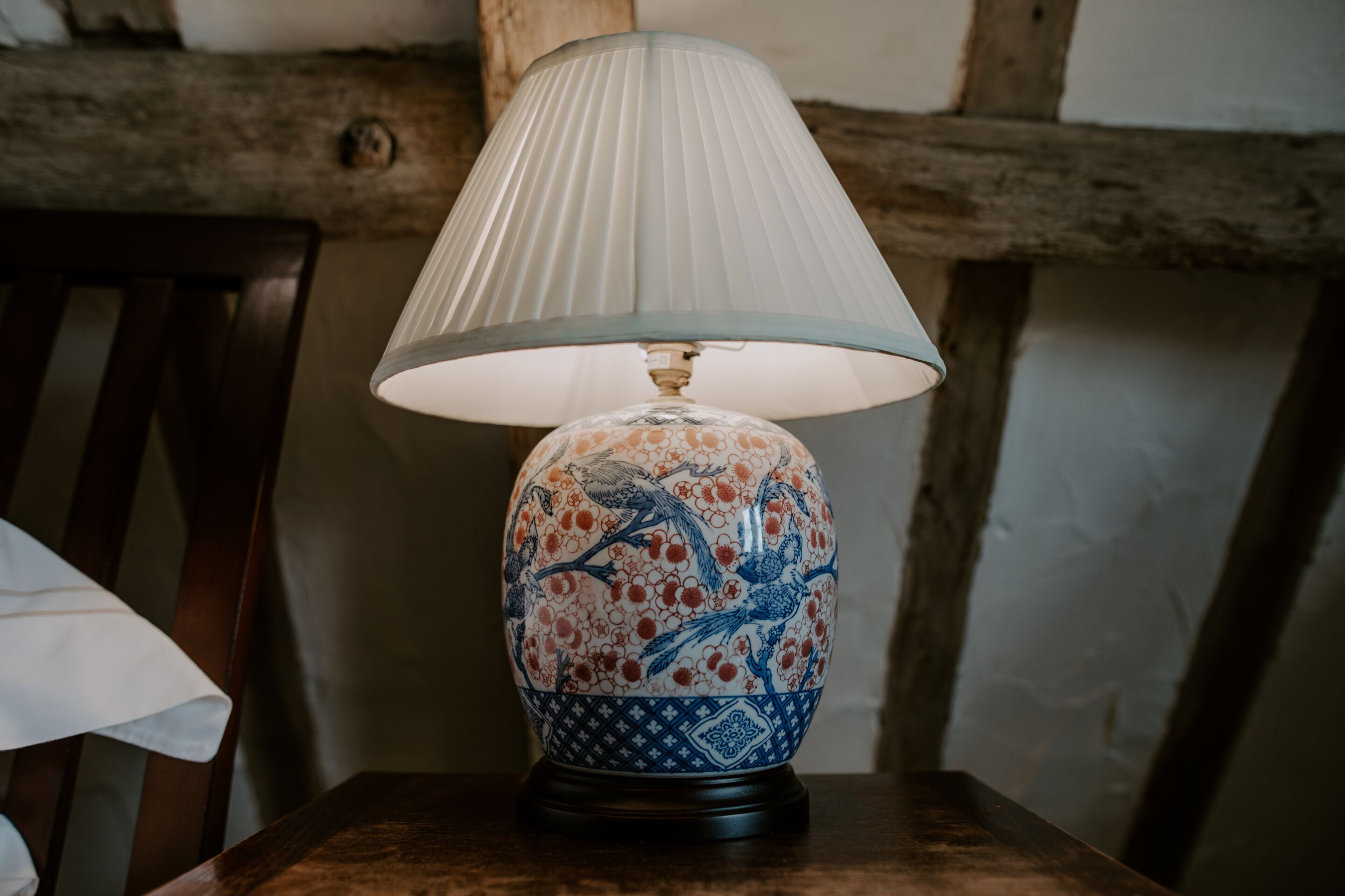 A table lamp with a blue and white ceramic base and a white lampshade.