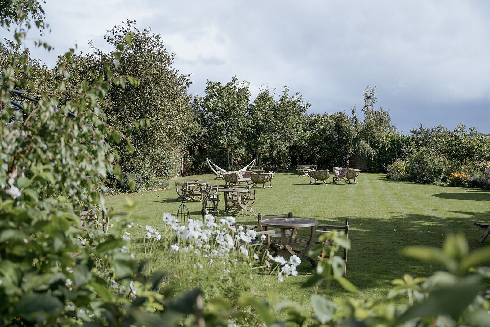 A garden with outdoor seating and a lawn.