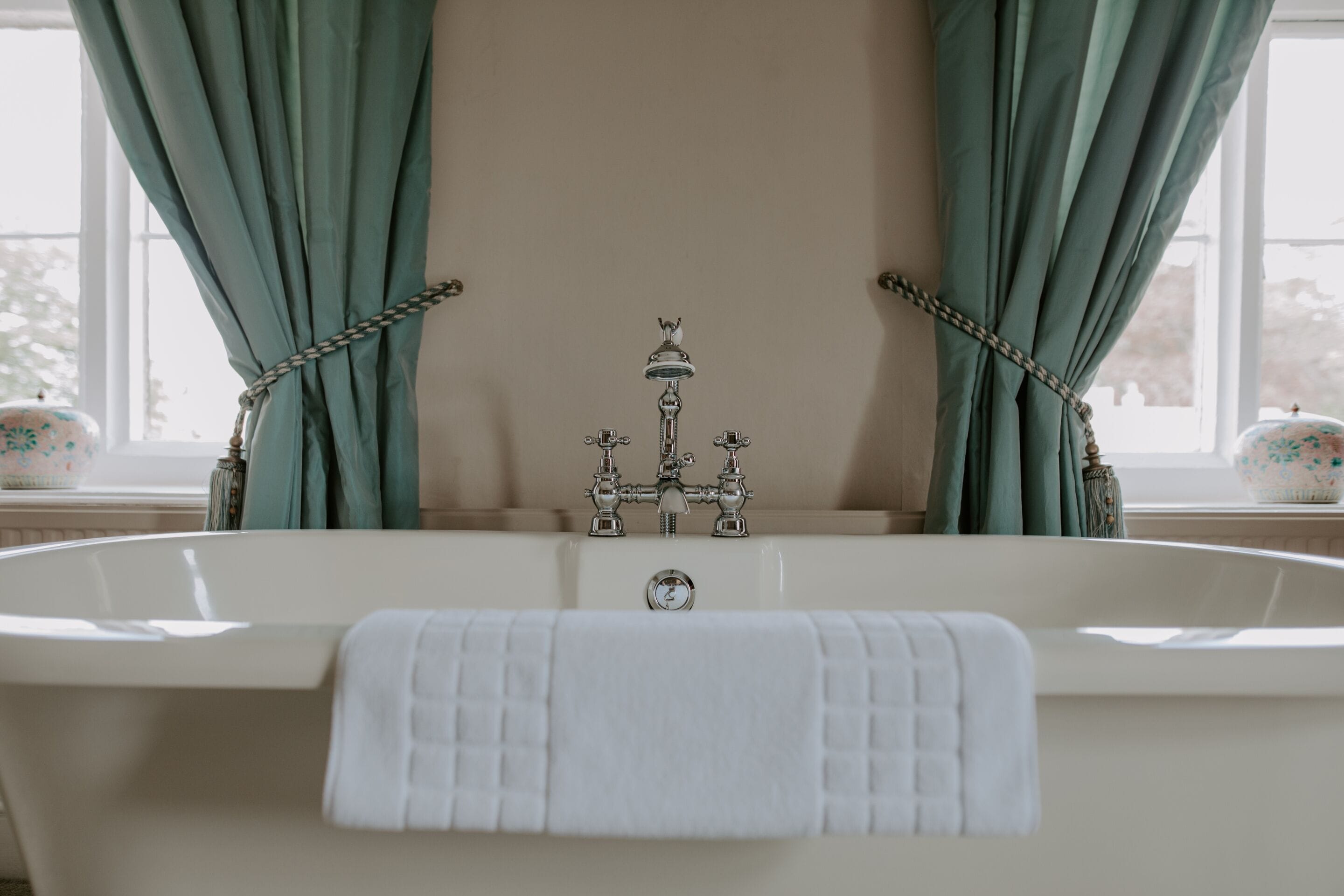 A bathtub with a faucet and a towel.