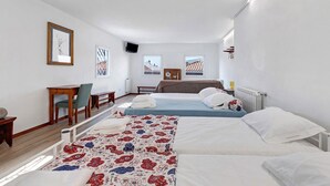 A hotel room with two beds, a desk, a chair, and a television. - Portas de Caminha III Studio with Shared Terrace, Balcony and Wi-Fi (Caminha)