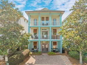 A two-story building with a balcony, a paved entrance, and a sign indicating no parking on the street. - Waterdog II | Community Pool/Hot Tub | Tram to Beach (Destin)