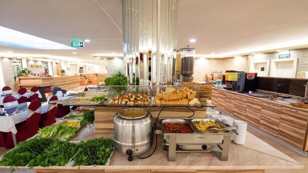 A buffet area with various food items and a coffee station. - Dınar Hotel (Istanbul)