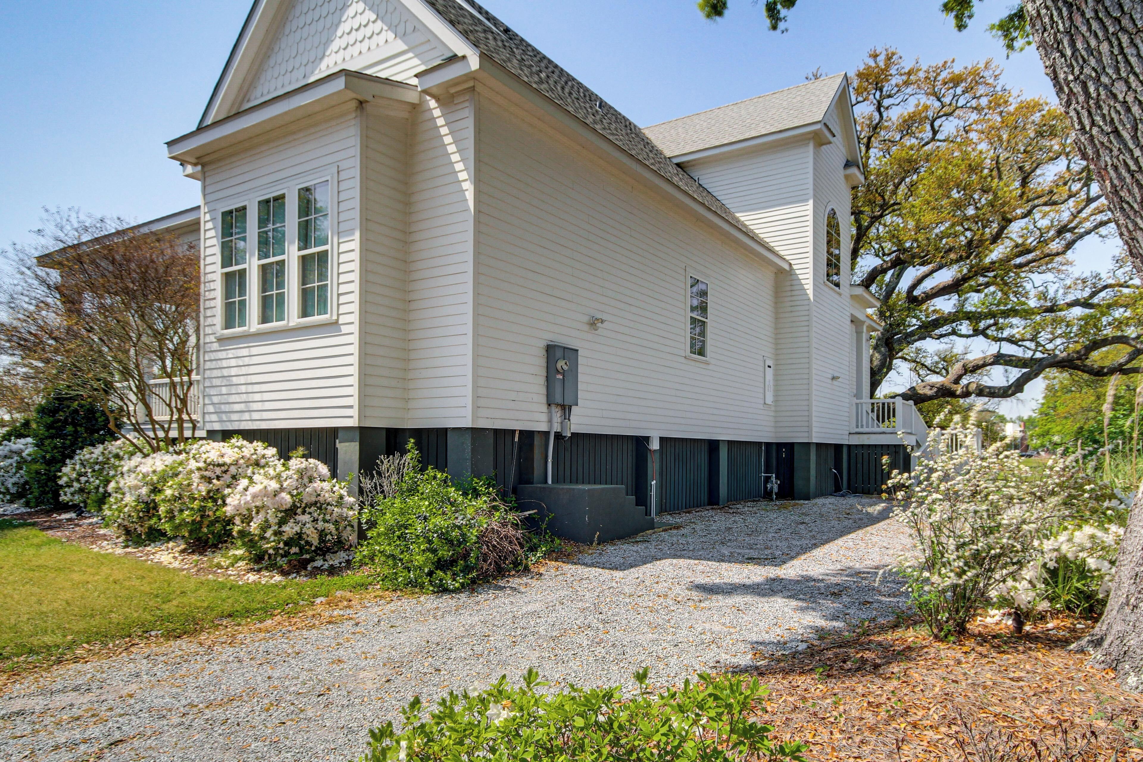 A two-story house with a front porch, a garage, and a driveway.