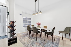 Gather around your stylish dining table for memorable meals with loved ones in this bright, modern space.