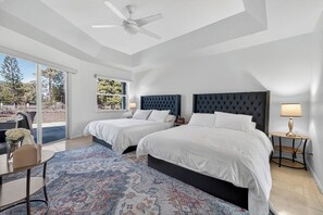 Drift off to sleep in this elegant twin bedroom with plush navy headboards, crisp linens, and natural light streaming through large windows. - Lox/Wellington Acreage Equestrians 5 beds Sleeps 10 (West Palm Beach)