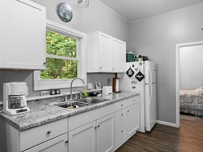 Fridge, microwave, coffee/tea maker, cookware/dishes/utensils