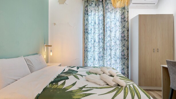 A bedroom with a bed, a wardrobe, and a desk. - Room 'Green Roof Palermo - 3 Rosmarino' with Balcony, Wi-Fi and Air Conditioning (Palermo)