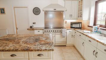 A kitchen with a stove, microwave, and cabinets.