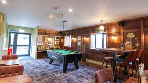 A billiards table, wooden walls, a fire exit sign, and a patterned carpet. - Mayfly Lodge (Bodmin)