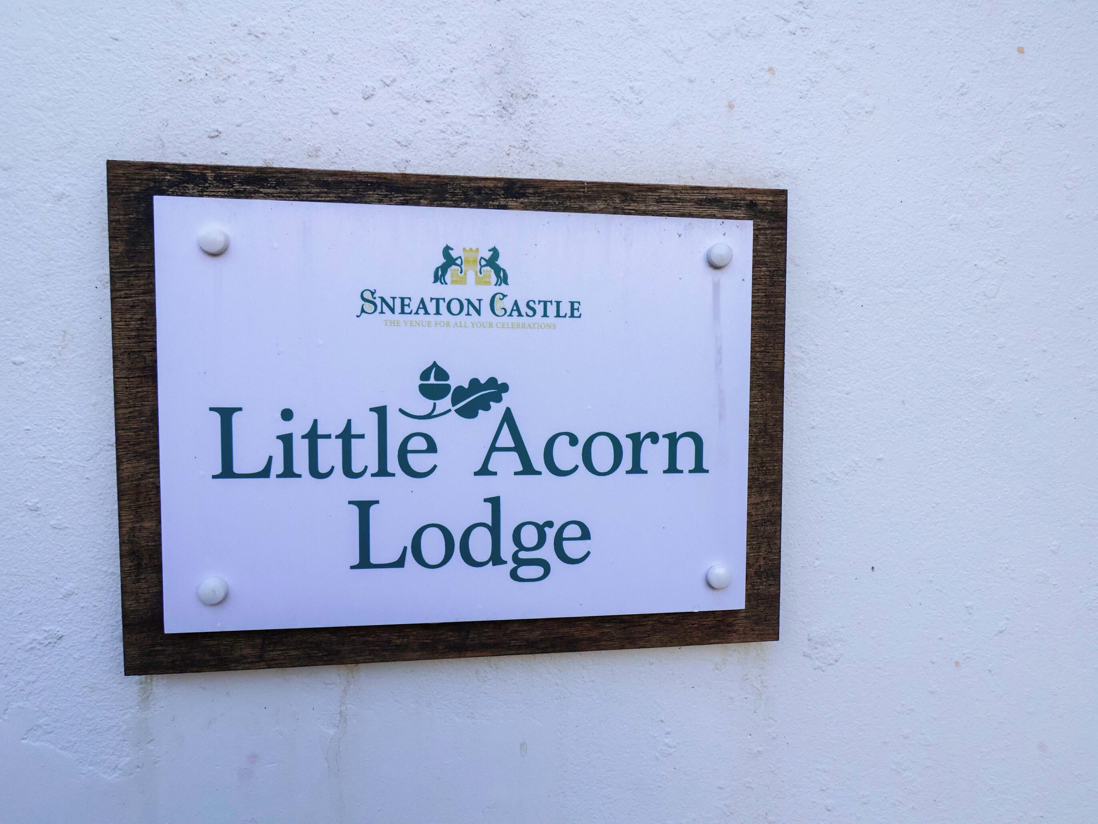 A sign for Little Acorn Lodge at Sneaton Castle, indicating it as a venue for celebrations.