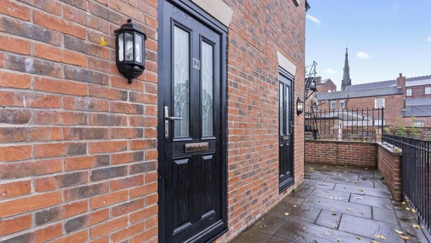 A brick building with a black door and a small window. - Amy`s House - close to the Peak District! (Alton Towers & Staffordshire Villages)