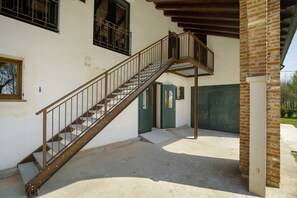 Una escalera que conduce a la entrada de un edificio, una puerta y una ventana.