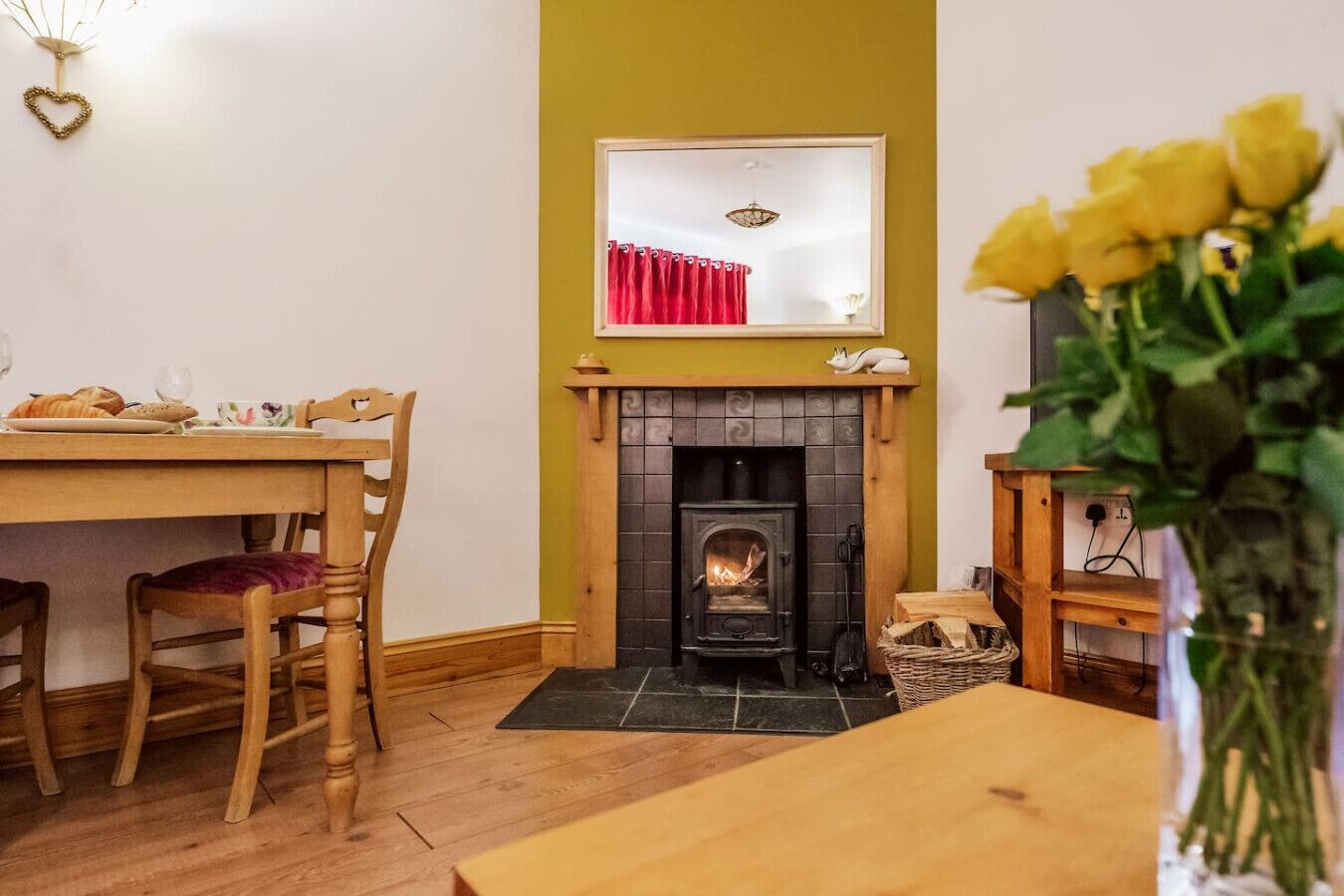 Una habitación acogedora con chimenea, muebles de madera y una mesa de comedor.