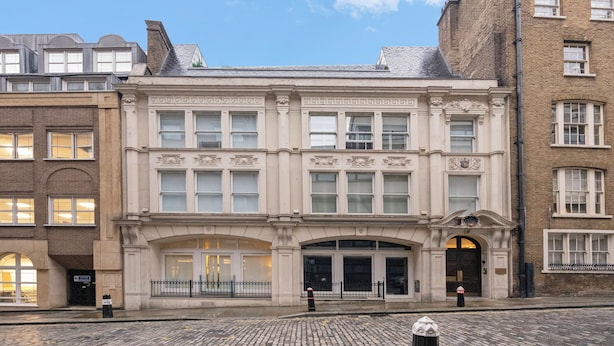A historic building with a classic facade, large windows, and an arched entrance. - The Monument Retreat near Bank Station (London)