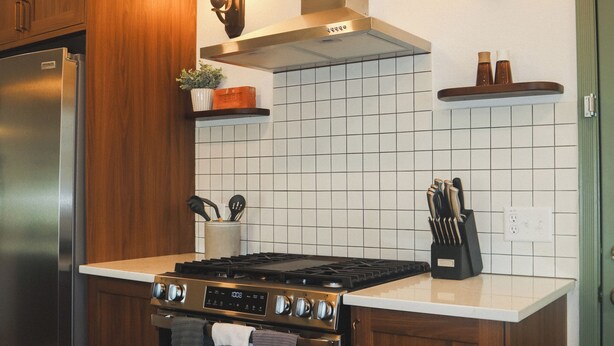 A kitchen with wooden cabinets, a stainless steel refrigerator, a gas stove, and a tiled backsplash. - Family-Friendly 3 Bedroom/2 Bath Home - 25 Min to Dallas w/ Free EV Charging (Forney)