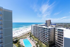A high-rise hotel with a pool, beach view, and multiple balconies. - Tradewinds #1108 - Beachfront 1BR + Bunks, Gulf View, Indoor/Outdoor Pool (Orange Beach)