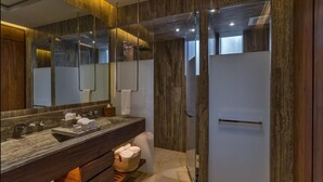 A modern bathroom with a marble vanity, a large mirror, and a glass shower enclosure. - 1-bedroom suite at Solaz, A Luxury Collection Resort, Los Cabos (San José del Cabo)
