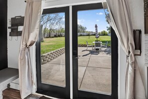 A room with a sliding glass door leading to an outdoor patio.