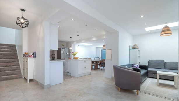 A modern interior with a staircase, a dining area, and a living room with a sofa and a coffee table. - Luxurious 3BDR 3BATH Hounslow by the Airport (Greater London)