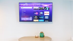 A flat-screen TV mounted on a wall displaying a Roku TV interface with various streaming services. - Twin View: 1 BR, Living Room, Ocean & Marsh Views, Beach Chairs, 1 parking spot (Hampton)