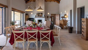 A dining area with a high wooden ceiling, a fireplace, and a large window. - I Tramonti 10+2, Emma Villas (Montegabbione)